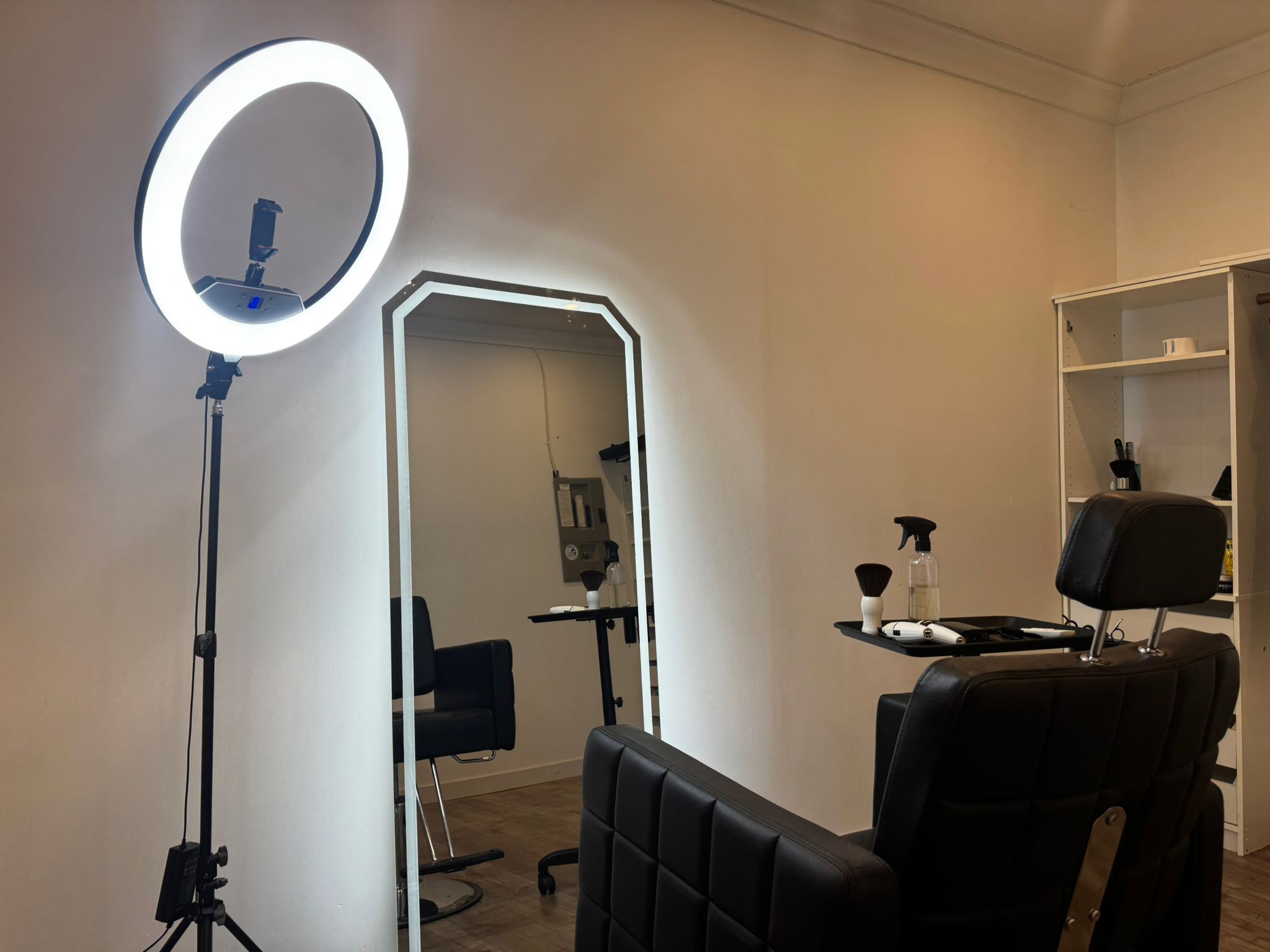 Full-length LED-edged mirror with clipped corners in the private studio